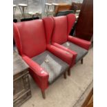 A PAIR OF RED LEATHERETTE PARKER KNOLL STYLE WINGED FIRESIDE CHAIRS