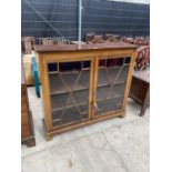 AN EDWARDIAN MAHOGANY AND CROSSBANDED ASTRAGAL GLAZED 2 DOORR BOOKCASE ON BRACKET FEET W:48"