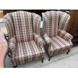 A PAIR OF WING BACK FIRESIDE CHAIRS ON FRONT CABRIOLE LEGS