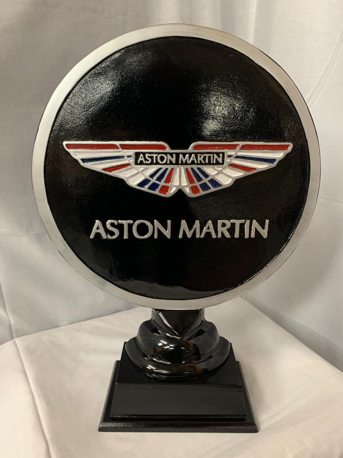 A LARGE ASTON MARTIN SIGN ON A WOODEN PLINTH H: APPROXIMATELY 52CM