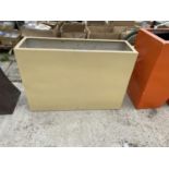 A LARGE BEIGE GARDEN PLANTER