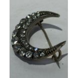 A 19TH CENTURY FRENCH SILVER CRESCENT BROOCH WITH CLEAR STONES