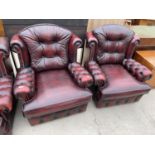TWO OXBLOOD LEATHER ARMCHAIRS WITH BUTTONED BACK AND ARMS