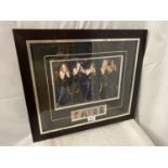 A FRAMED AUTOGRAPHED PHOTOGRAPH OF THE SATURDAYS