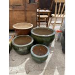 FOUR VARIOUS SIZED CERAMIC PLANTERS AND POTS