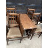 AN EARLY 20TH CENTURY OAK BARLEYTWIST GATELEG TABLE AND FOUR DINING CHAIRS