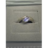 A 9 CARAT WHITE GOLD RING WITH PALE BLUE STONE SIZE J/K WITH A PRESENTATION BOX