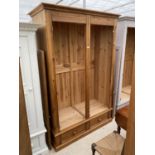 A MODERN PINE TWO DOOR WARDROBE WITH TWO DRAWERS TO THE BASE, 57" WIDE