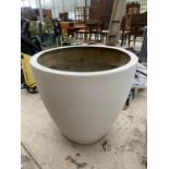 A LARGE ROUND AND CURVED FIBRE GLASS PLANTER (H:67CM DIAMETER:72CM)