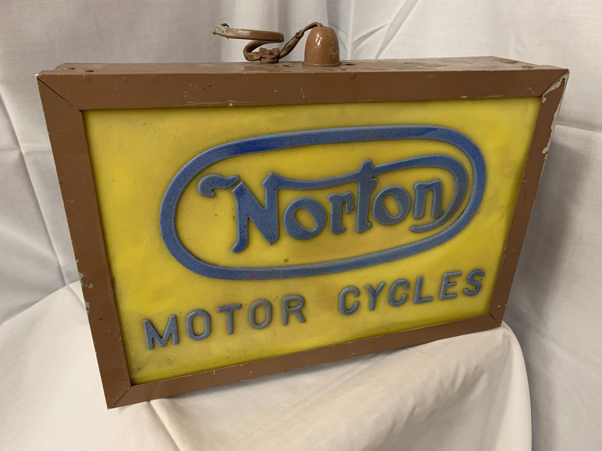 AN ILLUMINATED 'NORTON MOTOR CYCLES' SIGN