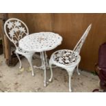 A WHITE CAST ALLUMINIUM BISTRO SET WITH A DECORATIVE ROUND TABLE AND TWO CHAIRS