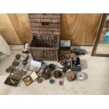 A VINTAGE WICKER BASKET WITH A LARGE COLLECTION OF FISHING TACKLE TO INCLUDE REELS, LURES AND FLOATS