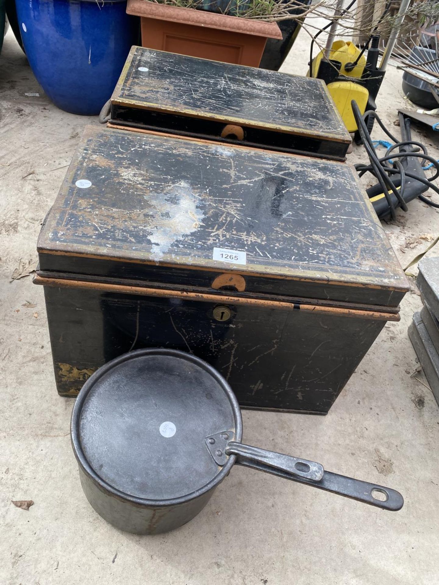 A PAIR OF METAL DEED TINS AND A CAST PAN