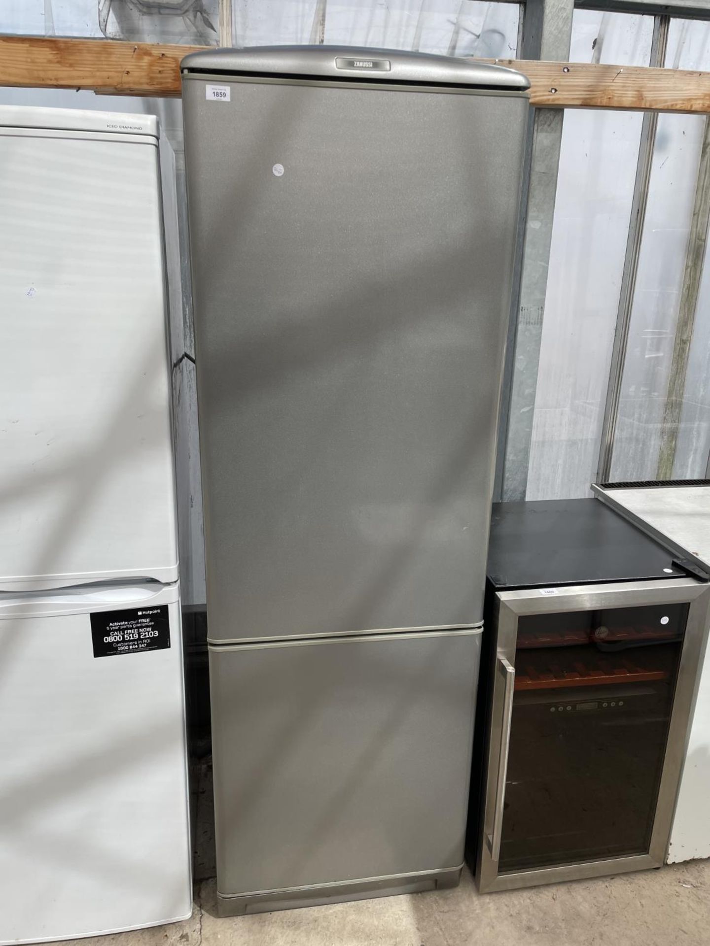 A SILVER ZANUSSI UPRIGHT FRIDGE FREEZER BELIEVED WORKING BUT NO WARRANTY