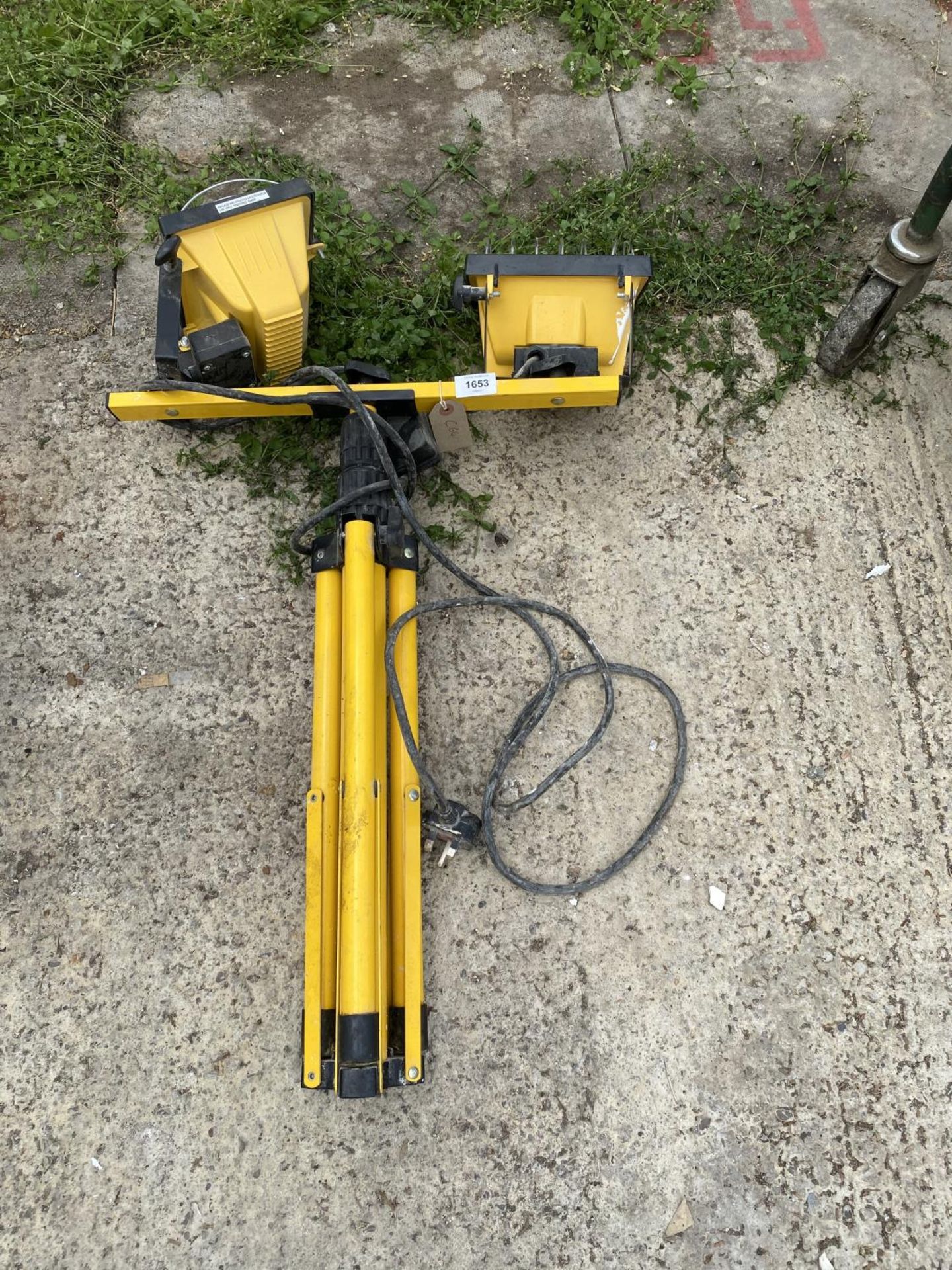 A TRIPOD STAND WITH TWO WORK SPOTLIGHTS