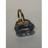 A 9 CARAT GOLD ART DECO STYLE RING WITH LARGE PALE BLUE STONE