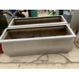 A PAIR OF SILVER RECTANGULAR FIBRE GLASS PLANTERS (95CM X 35CM X 31CM)