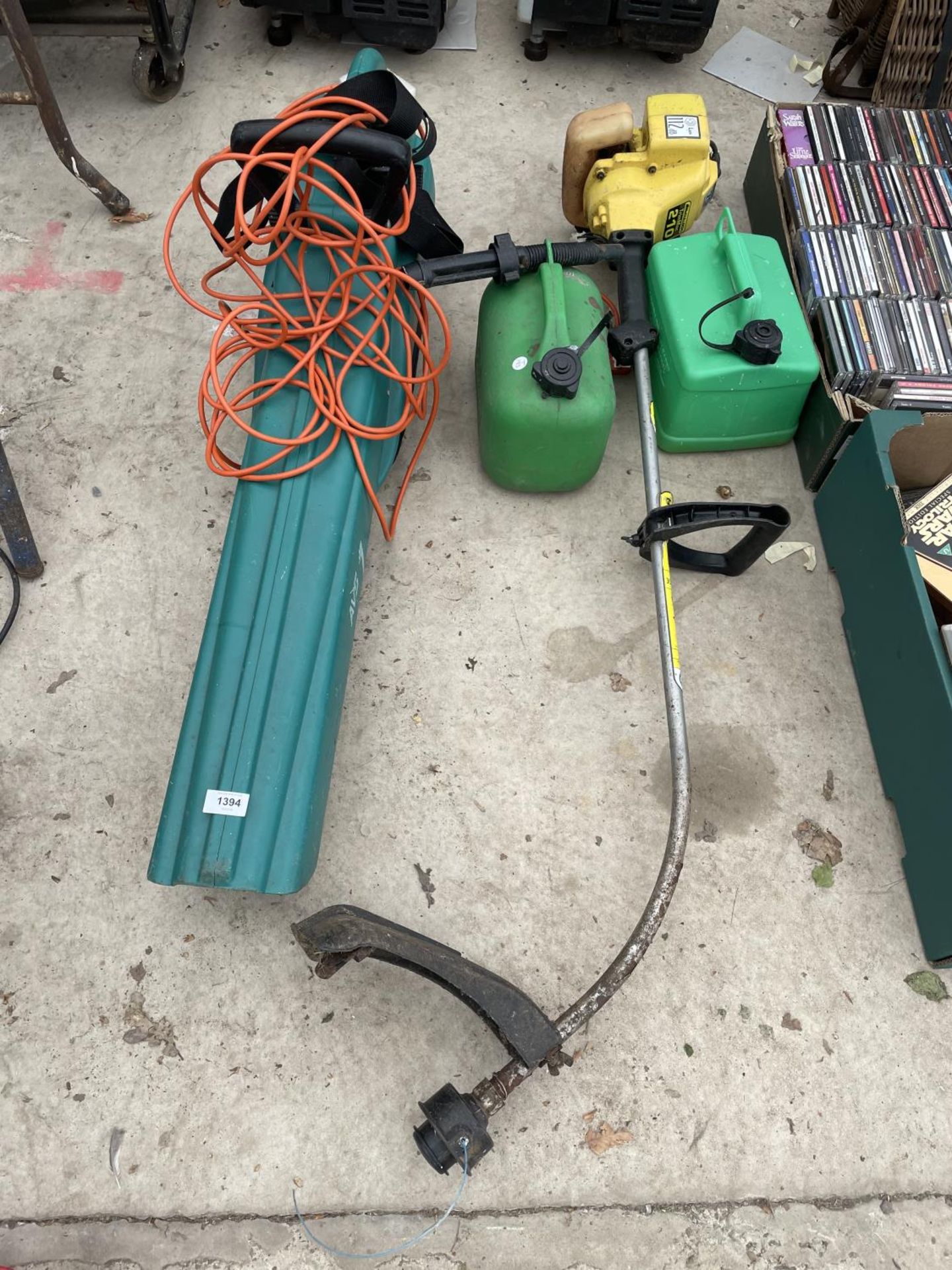 A LEAF BLOWER, TWO FUEL CANS AND A STRIMMER