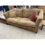 A VICTORIAN STYLE SETTEE ON TURNED LEGS