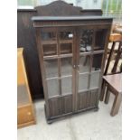 A PRIORY OAK CABINET WITH TWO GLAZED PANEL AND LINEN FOLD DOORS - 31.5" WIDE