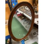 AN DECORATIVE OVAL MAHOGANY MIRROR 77CM HIGH