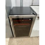 A STAINLESS STEEL AND BLACK HOOVER WINE FRIDGE BELIEVED WORKING BUT NO WARRANTY