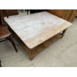 A RUSTIC PINE COFFEE TABLE WITH LOWER SHELF