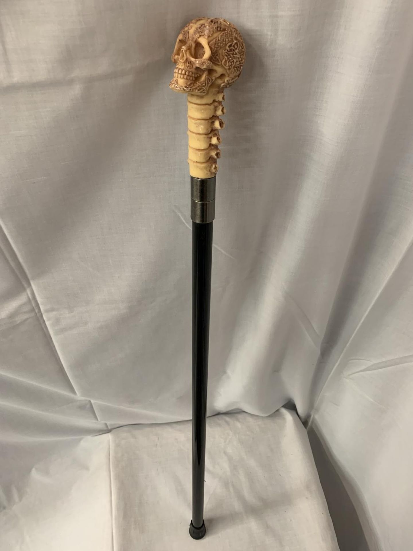 A SKULL HANDLE WALKING STICK