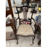 AN EDWARDIAN MAHOGANY ELBOW CHAIR ON FRONT CABRIOLE LEGS