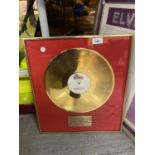 A FRAMED GOLD DISC PRESENTED T0 MUSIC ENTERPRISES FOR A PARTYMIX OF KYLIE MINOGUE, GREASE MEGAMIX