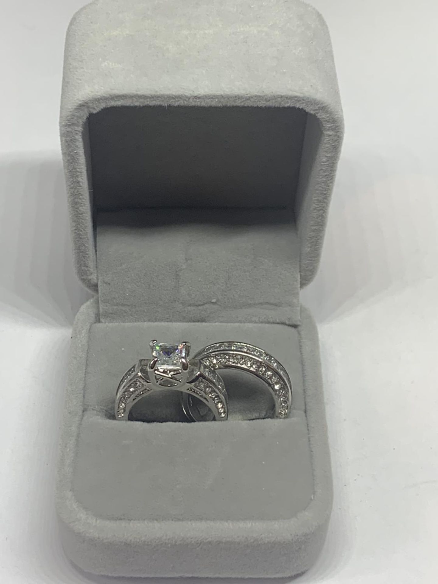 TWO MARKED 925 SILVER RINGS WITH CLEAR STONES ONE WITH A SOLITAIRE SIZE N IN A PRESENTATION BOX