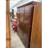 A MAHOGANY TWO DOOR WARDROBE WITH TWO DRAWERS BELOW