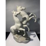 AN ITALIAN POTTERY FIGURINE OF A PAIR OF GALLOPING HORSES