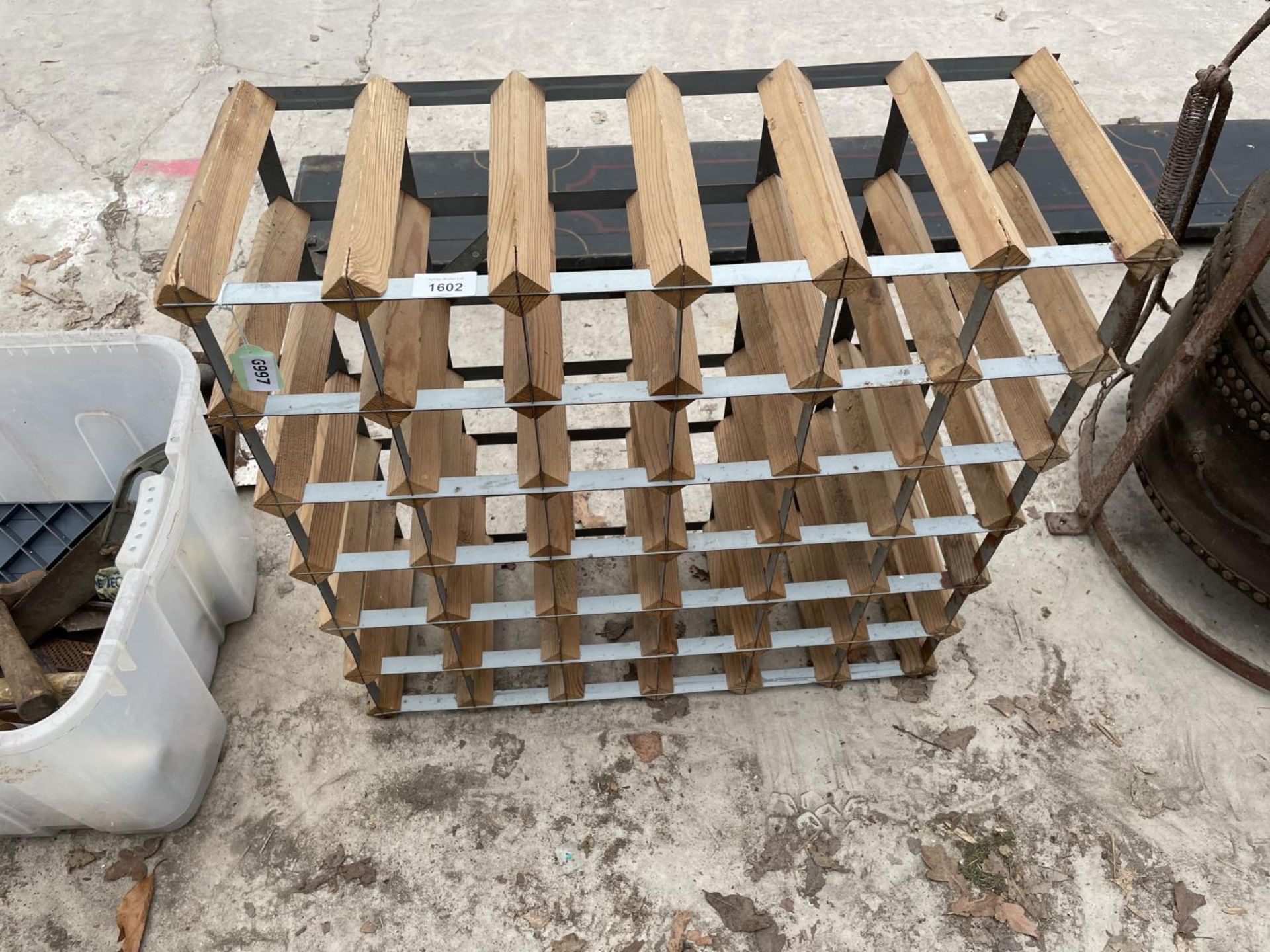 A WOODEN AND METAL BANDED WINE RACK