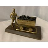A BRASS MINER AND COAL WAGON ON A WOODEN BASE