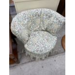 A MODERN BEDROOM CHAIR WITH FLORAL COVER