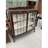 A MAHOGANY CHINA CABINET ON CABRIOLE SUPPORTS WITH GLAZED PANEL DOORS AND SIDES