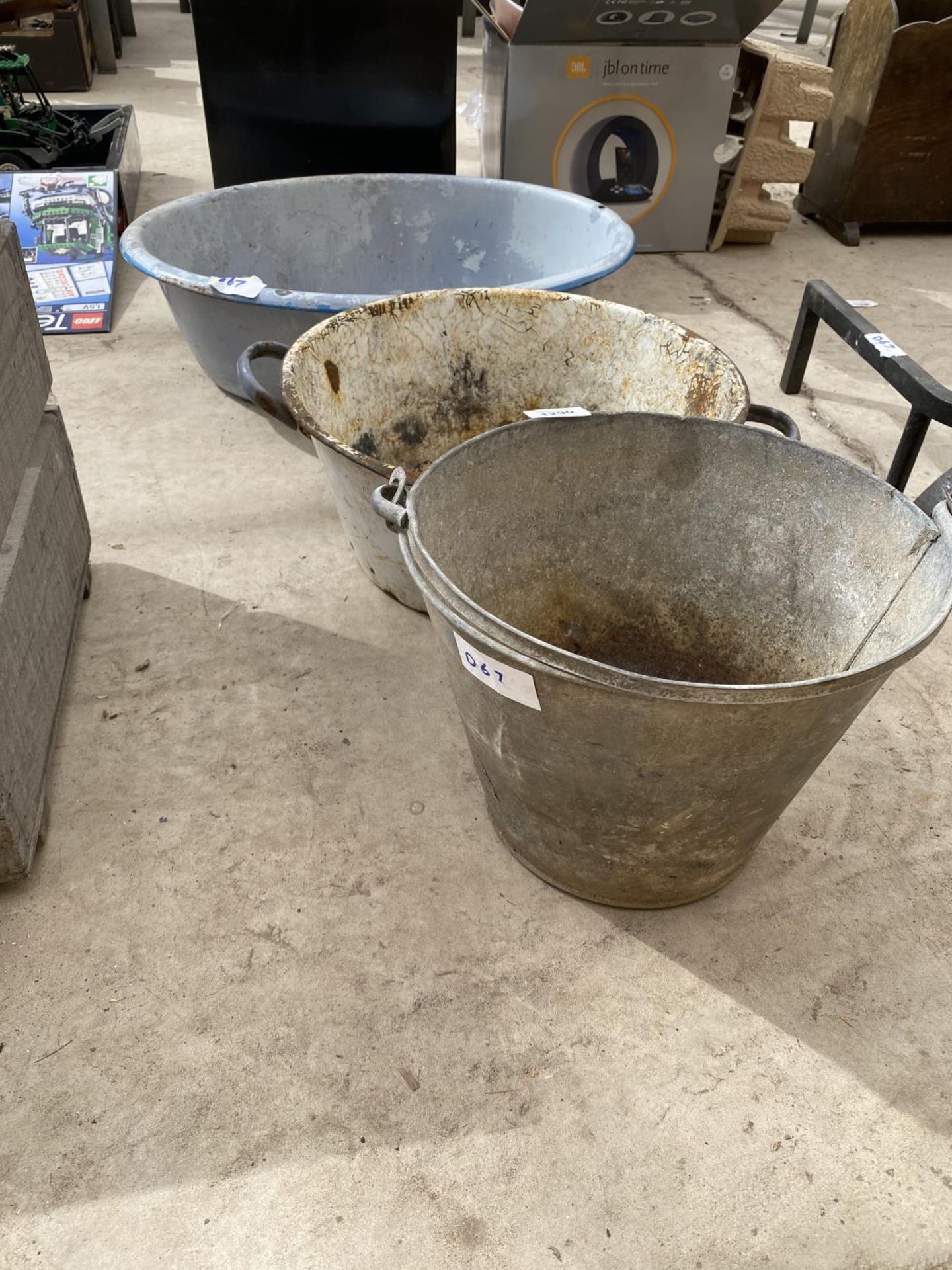 A GALVANISED BUCKET, AN ENAMEL PAN AND AN ENAMEL WASH BOWL