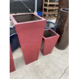 A TALL SQUARE RED FIBRE GLASS PLANTER AND A FURTHER SMALL RED FIBRE GLASS PLANTER (H:89CM AND 53CM)