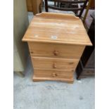 A PINE BEDSIDE CHEST OF THREE DRAWERS