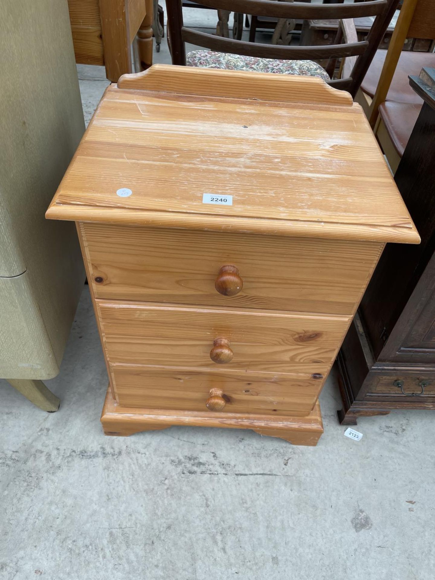 A PINE BEDSIDE CHEST OF THREE DRAWERS