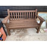 A WOODEN SLATTED GARDEN BENCH