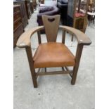 AN OAK ART NOUVEAU TUB CHAIR WITH PLATEAU ARMS AND HEART CARVING TO THE BACK, COMPLETE WITH