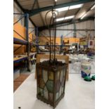 AN EARLY ORNATE METAL AND STAINED GLASS LIGHT FITTING WITH PULLEY