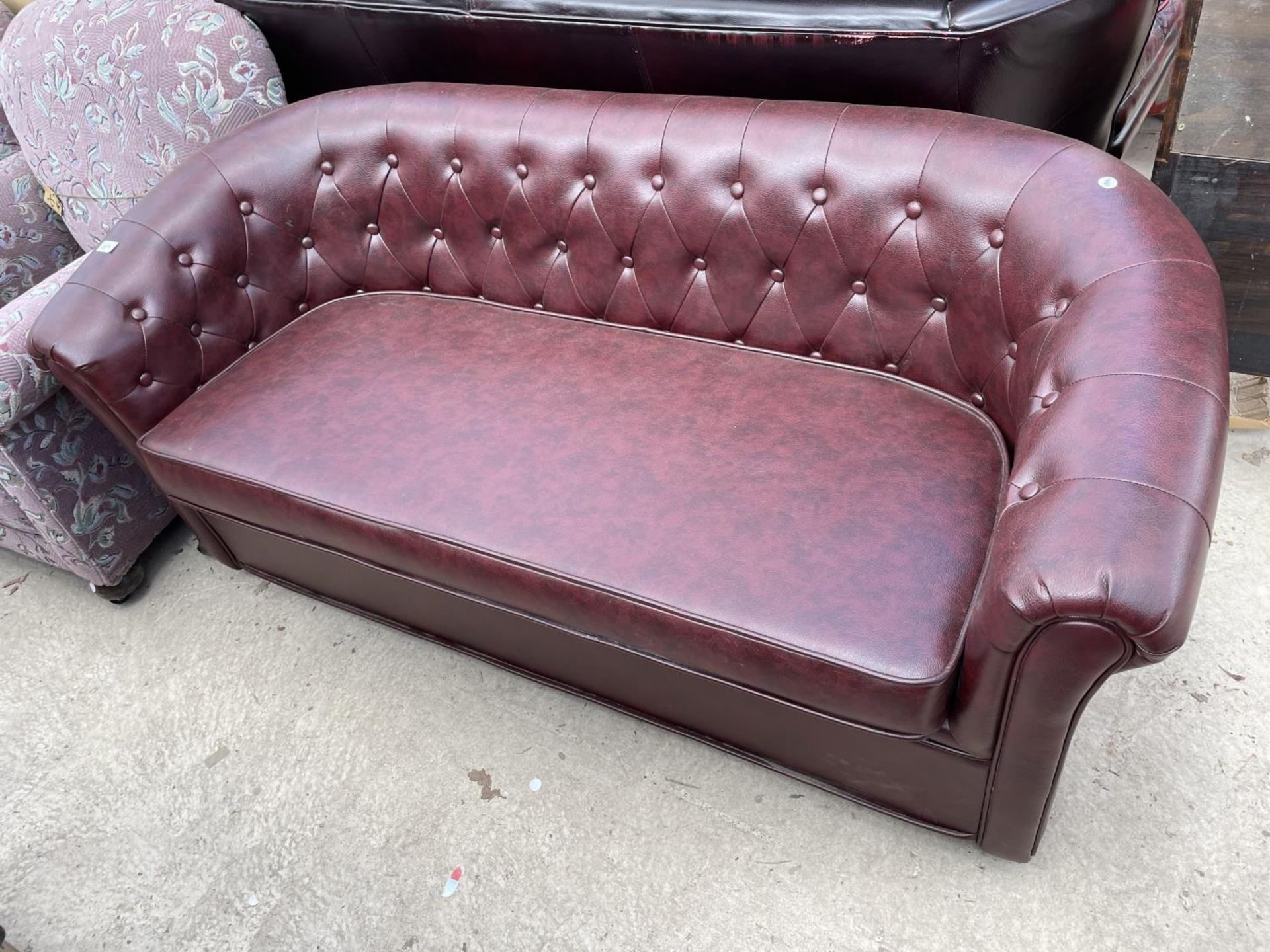AN OXBLOOD BUTTON-BACK CHESTERFIELD STYLE SETTEE