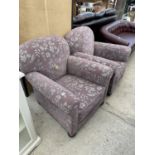 A PAIR OF EDARDIAN SPRUNG AND UPHOLSTERED EASY CHAIRS ON FRONT BUN FEET