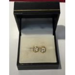 A PAIR OF 18 CARAT GOLD EARRINGS WITH POSSIBLY DIAMOND STONES IN A PRESENTATION BOX