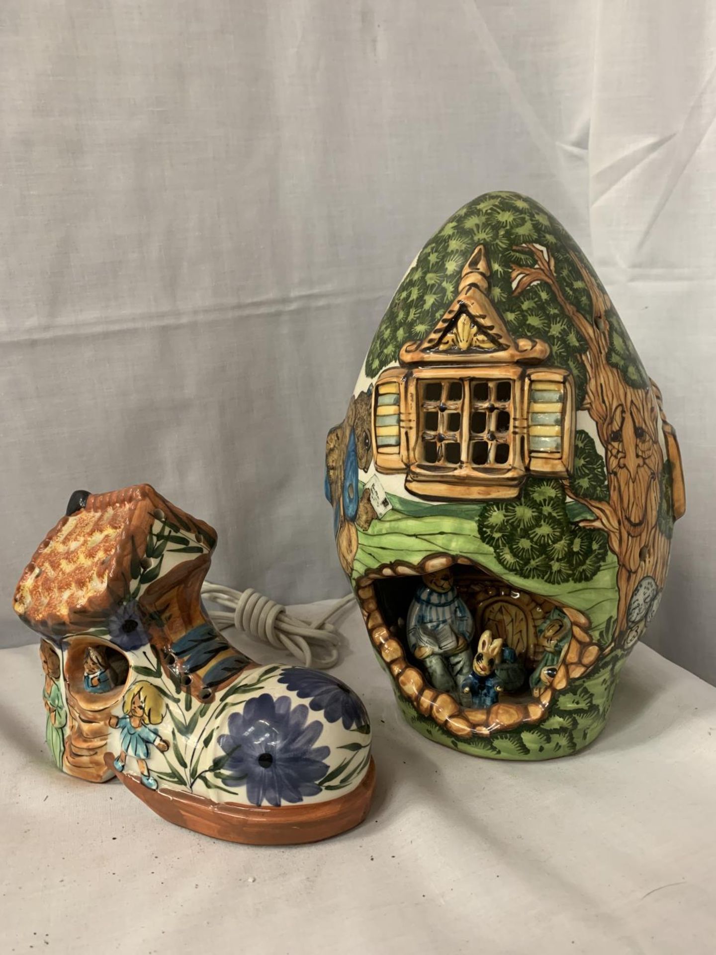 TWO CERAMIC CHILDREN'S NIGHTLIGHT LAMPS ONE BEING IN THE FORM OF A TREEHOUSE AND THE OTHER A BOOT