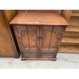 AN OLD CHARM STYLE TV CABINET WITH TWO DOORS AND LOWER LEAD GLAZED FALL FRONT