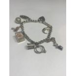 A HALLMARKED BIRMINGHAM SILVER CHARM BRACELET WITH EIGHT CHARMS